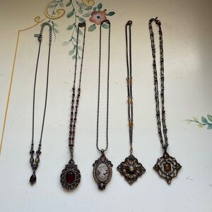 Five vintage brown and copper stone necklaces.